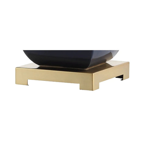Detail of the navy blue and gold base of the Navy Blue And Gold Ceramic Table Lamp With White Linen Shade, Modern Footed Vase Bedside Light