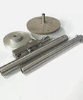 High-pressure waterjet tube bending tool kit: two stainless steel tubes, circular discs, and mounting block