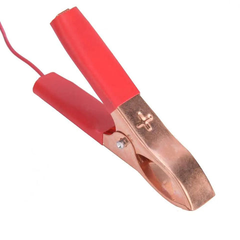 Close-up of a red and copper clamp for 20W Monocrystalline Solar Charger Outdoors With Dual DC Output And USB Goes Off Grid For 12V Batteries Powers Camping And RV Life Weatherproof Silicon Panel High Efficiency Eco Friendly.