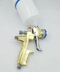 Straight Up Professional Pneumatic Paint Spray Gun Featuring High Atomization Nozzle Gravity Feed Build for Car Painting and Leather Repair Jobs. Gold spray gun with top-mounted reservoir.