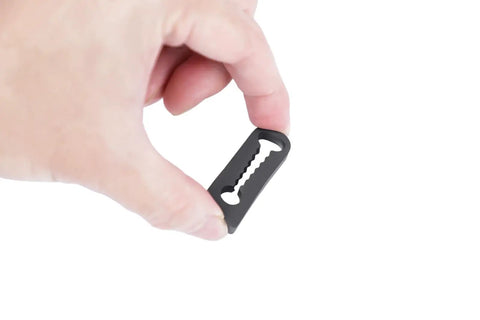 Universal Vehicle Door Buffers Knock Back The Heavy Slam With Chunky Silicone Shock Absorbers and Grip Tight Latch Protectors For Pickup Trucks Jeeps and Road Cruisers, black silicone buffer pad held in hand.