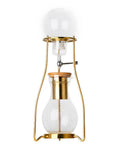 Craft Hella Smooth Cold Brew Coffee And Iced Tea With This No Sweat Dripper Featuring Adjustable Water Flow Stainless Steel Filter And Spacious Glass Carafe For Daily Sipping with gold details and wood lid.