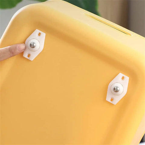 Heavy Duty Self Adhesive Furniture Casters With Stainless Steel Swivel Rollers And 360 Degree Glide Wheels attached to a yellow storage bin.