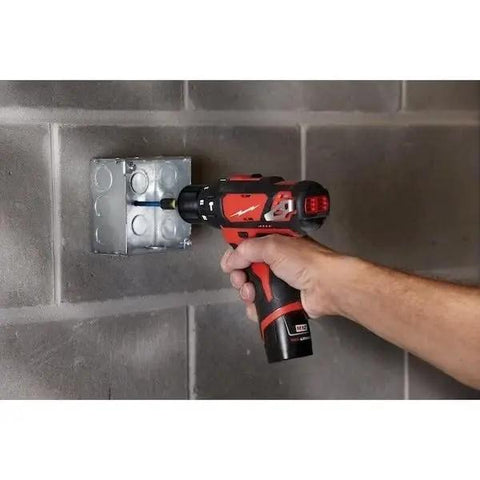 Heavy Hitter Cordless Compact Rotary Hammer Drill Driver Kit using variable speed to drill into concrete box.