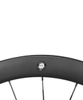 Close-up of Carbon Disc Road Wheelset 50TU-28-DB Tubeless 700C showcasing UCI approved label on black 50mm rim.