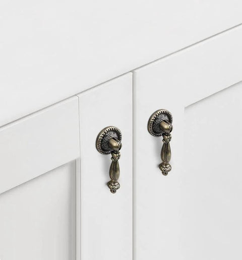 Front view of 4 Pack Decorative Bronze Drawer Pulls Set With Screws Vintage Copper Door Handles on white cabinet doors