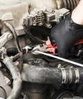 Black nitrile disposable gloves worn by a mechanic while working on a car engine