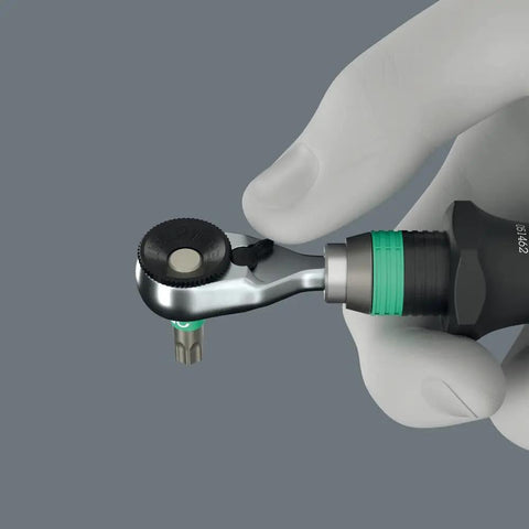 Hand holding Zyklop Mini 4 Bit Ratchet One Quarter Inch Drive Fifty Millimeter Hex Bit Holder with thumbwheel visible.