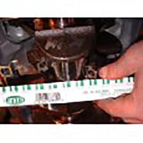 Plastigage strip, green, for engine bearing clearance, shown beside a tape measure.