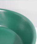 Close-up of the dark green surface of a Bathroom Sink Bathroom Round Non-Porous Ceramic Wash Basin.