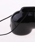 Side view of a black PVC valve cover cap with retainer cord from the Scuba Tank Valve Cover Caps Kit For York A-Clamp Cylinders 8 Pack.