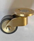 Close-up of a single brass caster from Set Of Four 25 Mm Solid Brass Casters With 1 Inch Rubber Wheels, 360 Degree Swivel, Round Cup Style