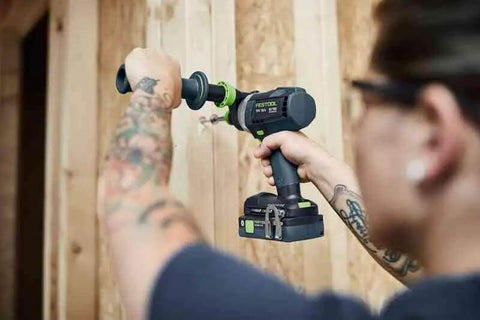 Heavy Duty Cordless Percussion Drill With Real Deal Masonry Punching Power And Smooth Woodworking Flow Including Forstner Bit Compatibility Plus No Nonsense Workhorse Design Tool Only in use with a wooden wall.