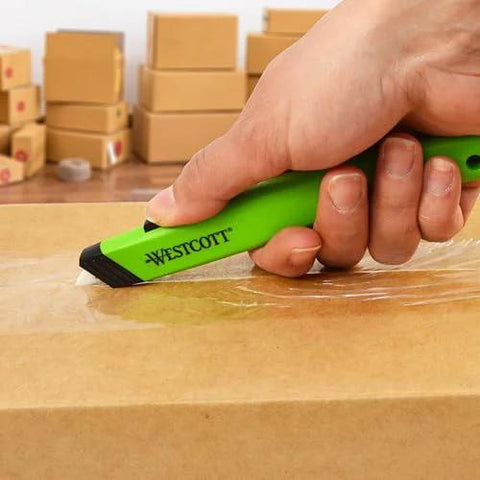 Westcott safety ceramic utility knife, green handle, cutting cardboard (close-up)