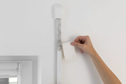 Top Tier Blind Strap Replacement Kit For Retractable Window Coverings with heavy duty grey straps attached to a wall during installation.