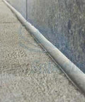 Polyurethane Construction Sealant 525 Gray 10.5 oz cartridge sealing a concrete joint; shown with the product in use on stone surface.