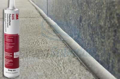 Polyurethane Construction Sealant 525 Gray 10.5 oz cartridge sealing a concrete joint; shown with the product in use on stone surface.
