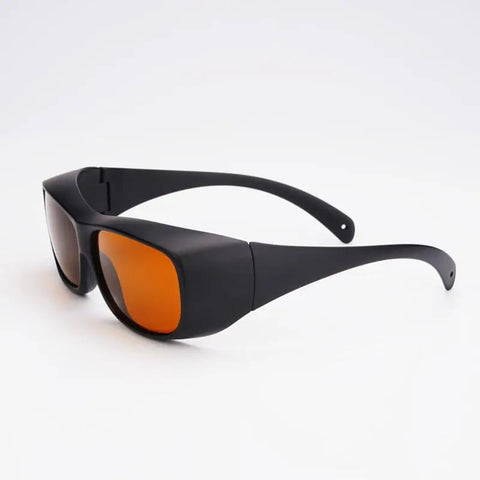 Professional Grade Kickass Laser Safety Glasses With Hella Od5 Plus Eye Defense Across One Hundred Ninety To Eleven Hundred Nanometer Wavelength Range For Spa Studios And Beauty Clinics In Classic Orange Lens, side view.