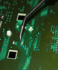 Close-up of circuit board with soldering tool, part of Six Piece Stepper Motor Repair Kit X27.168 For Chevy GM GMC Dash Gauges 2003 2006