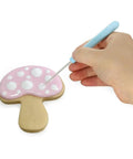 Four Piece Sugar Stir Needle Set And Gotta Have Cookie Decorating Tools Featuring Smooth Plastic Grips For Quick Icing Outlining Cake Embossing And Syrup Mixing used for decorating a pink mushroom cookie.