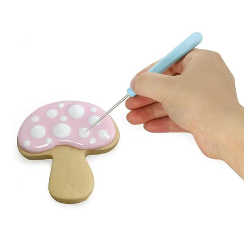 Four Piece Sugar Stir Needle Set And Gotta Have Cookie Decorating Tools Featuring Smooth Plastic Grips For Quick Icing Outlining Cake Embossing And Syrup Mixing used for decorating a pink mushroom cookie.