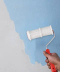 Person using Pro Grade Texture Paint Roller Delivers Killer Brick and Rustic Stone Looks on Interior Walls with blue paint.