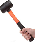 Hand holding 16 Oz Rubber Mallet Hammer With Fiberglass Handle And Shock Absorption Soft Blow Hammer For Flooring Tent Stakes Woodworking Camping And DIY Projects Ergonomic Non Slip Grip