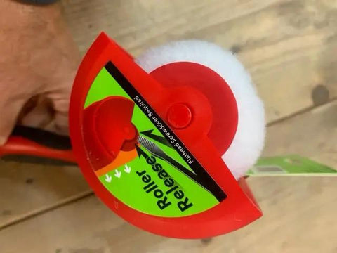 Nine Inch Paint Roller With Integrated Anti Splatter Shield And Heavy Duty Rubber Grip For No Sweat Wall Painting Plus Threaded Socket Attaches To Standard Poles Slick Smooth Coat Reusable Nap Cover Pack Of Ten, top view with roller release feature.