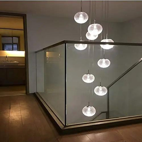 Top Tier Modern Chandelier With Round Glass Globes And Sleek Metal Frame Delivers A Heck Of A Statement For Staircases Or Spacious Living Rooms Featuring Easy Screw In Bulbs That Instantly Dial Up The Home Vibes, hanging above stairs.