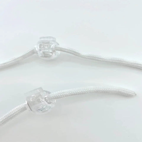 Close-up of Roman Shade Orbs Lock Rope Buckle Kit for Easy Leveling of Window Treatments, transparent with adjustable rope.