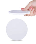 Hand holding 144 Pcs Round Coaster Blanks 4.25 Inch Ceramic Tiles With Cork Backing, Sublimation Blanks for DIY projects