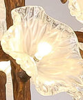 Close-up of Tree Branch Ceiling Pendant Light Straight Up Fresh Statement Chandelier with clear glass flowers and warm illumination.