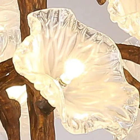 Close-up of Tree Branch Ceiling Pendant Light Straight Up Fresh Statement Chandelier with clear glass flowers and warm illumination.