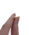 Straight Premium 6MM Gold Filled Round Beads For Jewelry Crafting, showing hand holding a bead with 1.5mm hole.
