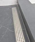 48 Inch Linear Shower Drain Slick Brushed Nickel Stainless Steel Side Outlet Offset Bundle With Rubber Gasket And Super Fine Hair Strainer For Modern Bathroom Plumbing Smooth Flow Top Tier Traditional Square Design Easy Setup on tiled floor.