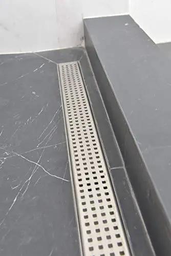 48 Inch Linear Shower Drain Slick Brushed Nickel Stainless Steel Side Outlet Offset Bundle With Rubber Gasket And Super Fine Hair Strainer For Modern Bathroom Plumbing Smooth Flow Top Tier Traditional Square Design Easy Setup on tiled floor.