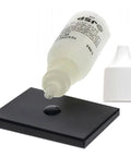 Waytest silver testing solution bottle; white dropper bottle with liquid on black testing tile