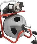 K Four Hundred Power Rodder Drain Cleaning Machine With Hella Durable Three Eighths Inch Cable Seventy Five Feet Long And Killer Two Thirty Volt Motor For Serious Pipe And Conduit Upkeep on a red and grey frame.