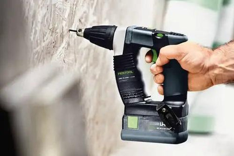 Hardcore No Fuss Cordless Construction Screwdriver With Brushless Motor Tech shown in use, driving screws into a wall, compact design.