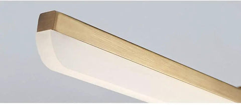 Close-up of Lit Vanity Light With Brushed Brass Arc Arm Sconces Long Acrylic Linear Wall Light In Gold