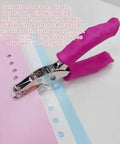 1/4 Inch Pink Handheld Circle Hole Punch For Crafting with pink handle, shown punching holes in cardstock for scrapbooking projects