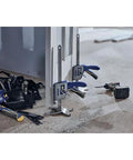 IRWIN Quick-Lift construction jacks with blue handles, three units leaning against a metal frame on a construction site.