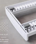 Close-up of StoreMore Adjustable Bakeware Rack With Steel Wires Seven Adjustable Dividers showcasing non-slip base feature.