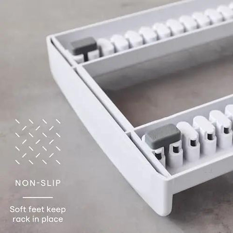 Close-up of StoreMore Adjustable Bakeware Rack With Steel Wires Seven Adjustable Dividers showcasing non-slip base feature.