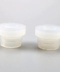 Two white polymer bushings from GM Corvette Shift Cable Bushing Repair Kit For 1997-2013 C5 Models Easy Plug And Play Replacement