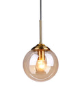 Industrial Retro Loft 3 Way Pendant Light With Glass Globe Lampshades In Amber, brass fittings, single globe close-up view.