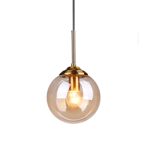 Industrial Retro Loft 3 Way Pendant Light With Glass Globe Lampshades In Amber, brass fittings, single globe close-up view.
