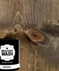 No Brainer Walnut Aging Wood Stain In 5 Gallon Pails next to rough cut walnut wood showcasing natural grain texture.