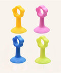 Four colorful silicone door stopper and wall protector with soft closing damper for noise reduction and wall protection.