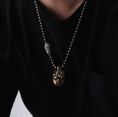 Beating Mechanical Heart Pendant Necklace Steampunk Style Jewelry With Gears And Vascular Details on model black shirt